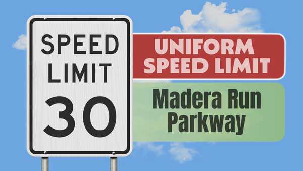 Speed Limit 30 sign in the foreground with a blue sky and clouds. To the right, red and green banners read Uniform Speed Limit and Madera Run Parkway.